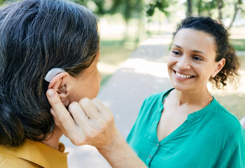 Woman managing her hearing loss with hearing aids