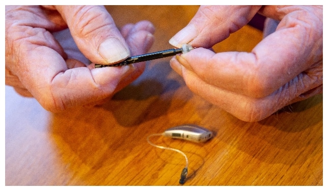 Professional cleaning a hearing aid